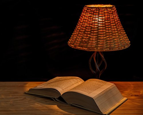 Cozy reading space with a modern desk lamp providing targeted warm light